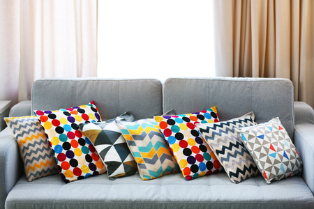 Stylish pillows on grey couch