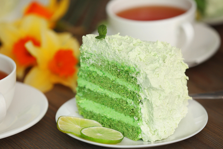 Piece of delicious creamy lime cake on wooden table closeupの写真素材