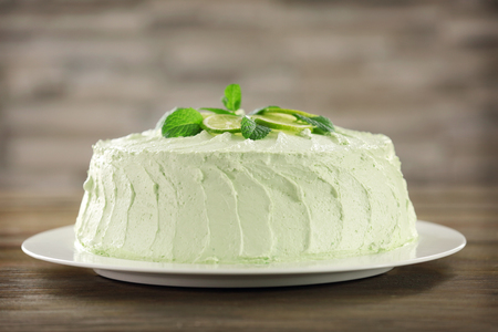 Delicious creamy lime cake on blurred backgroundの写真素材