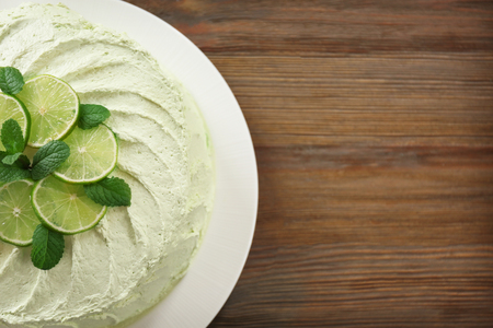 Delicious creamy lime cake on wooden table, top viewの写真素材