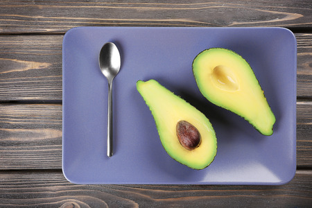 Fresh avocado in plate, top viewの写真素材