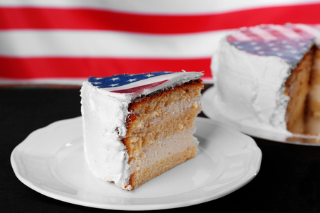 Piece of American flag cake, on black wooden background.の写真素材