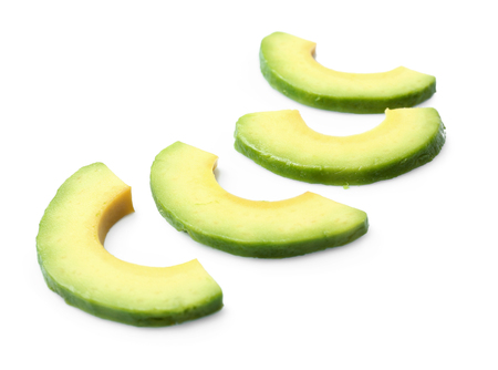 Pieces of avocado isolated on whiteの写真素材
