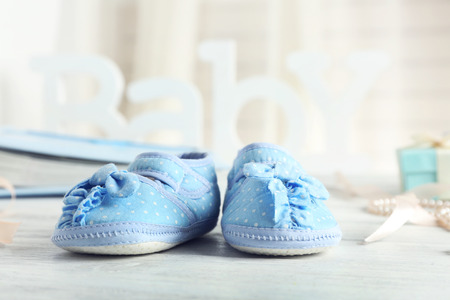 Beautiful composition with baby booties on wooden backgroundの写真素材
