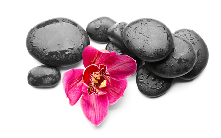 Spa stones and red orchid isolated on whiteの写真素材