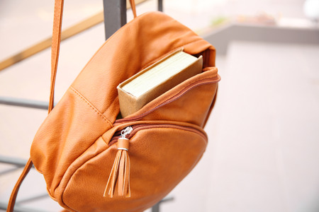 Hanging backpack with book closeupの写真素材