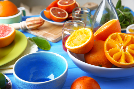 Juicing delicious citruses on blue wooden tableの写真素材