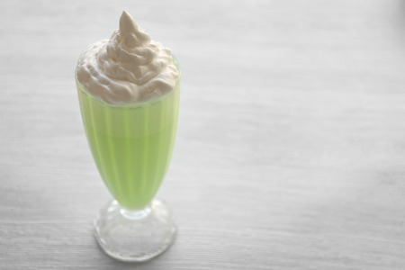 Delicious milkshake on wooden table