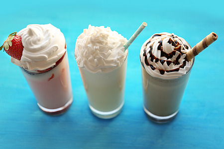 Delicious milkshakes on wooden tableの写真素材