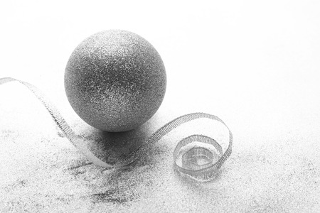 Christmas ball with ribbon on light textured backgroundの写真素材