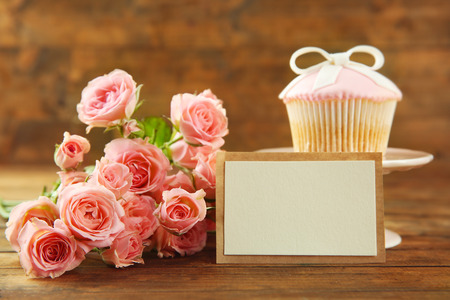 Fresh roses and present on wooden backgroundの写真素材