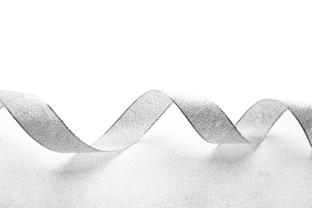 Grey ribbon on light textured backgroundの写真素材