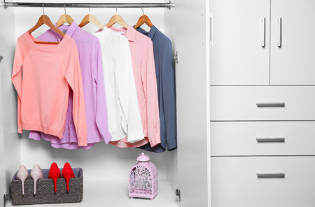 Female clothes hanging in wardrobe