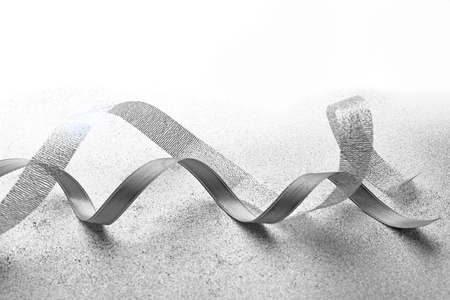 Grey ribbons on light textured backgroundの写真素材