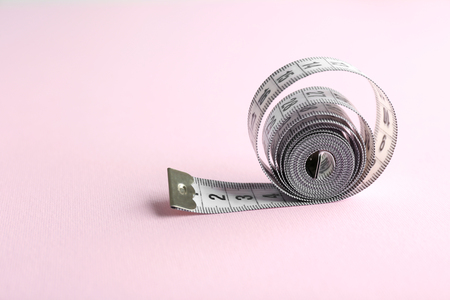 Measuring tape  on pink backgroundの写真素材