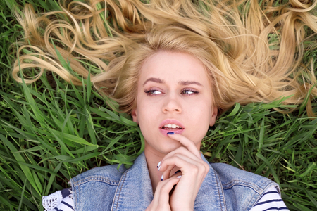 Young beautiful woman on green grassの写真素材