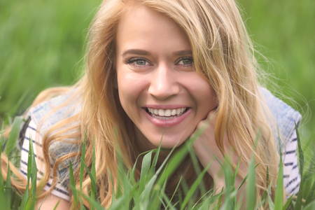 Young beautiful woman on green grassの写真素材