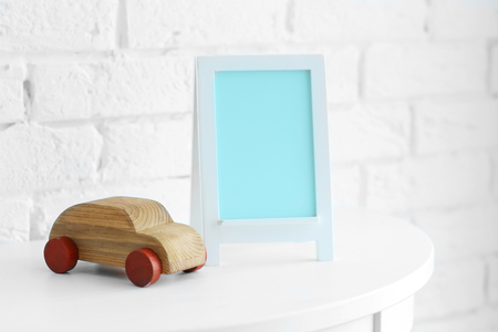 Baby toy and frame on brick wall backgroundの写真素材