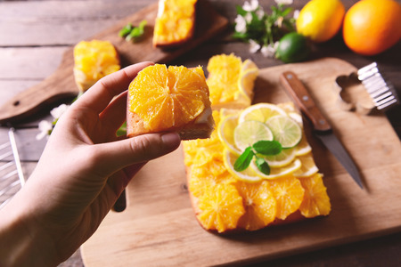 Woman holding a piece of delicious citrus cakeの写真素材