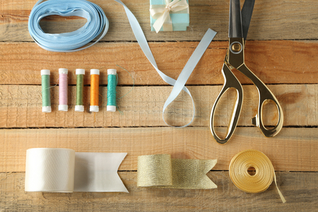 Sewing creative accessories on wooden background, top viewの写真素材