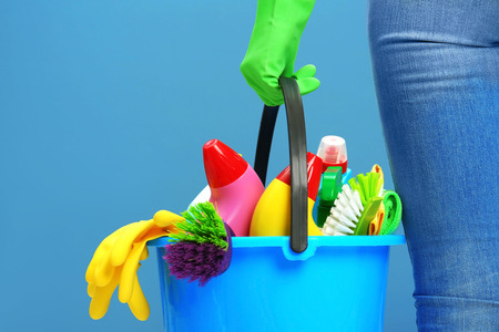 Female cleaner on blue backgroundの写真素材