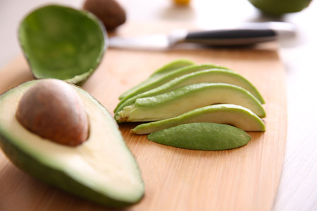 Fresh sliced avocado on cutting boardの写真素材