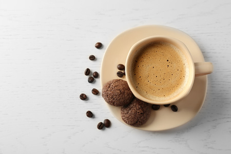 Cup of coffee with cookies on wooden tableの写真素材