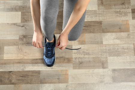 Woman hands tying sport shoesの写真素材