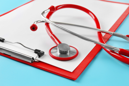 Red stethoscope with prescription on blue backgroundの写真素材