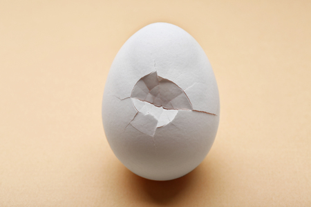 Cracked egg on color backgroundの写真素材