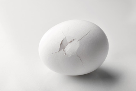 Cracked egg on white background