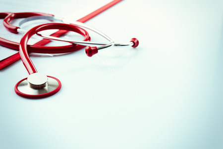 Red stethoscope and prescription isolated on whiteの写真素材
