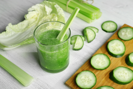 Fresh healthy vegetable smoothie with ingredients on wooden tableの写真素材