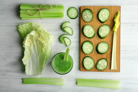 Fresh healthy vegetable smoothie with ingredients on wooden tableの写真素材