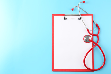 Red stethoscope with prescription on blue backgroundの写真素材