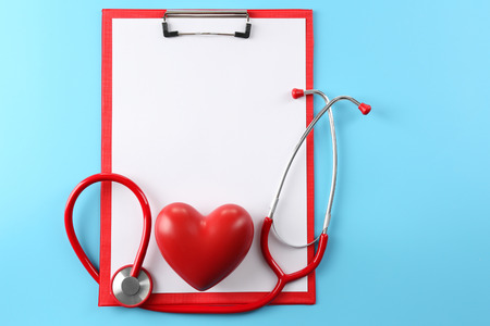 Red stethoscope with prescription on blue backgroundの写真素材