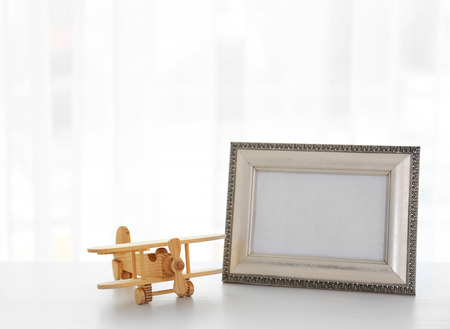 Child toy with frame on white wooden tableの写真素材