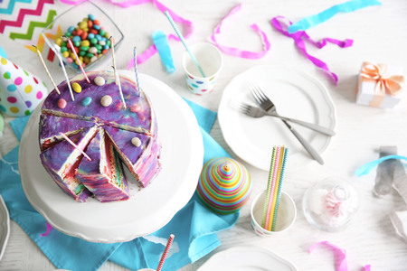 Sliced colorful cake on festive table