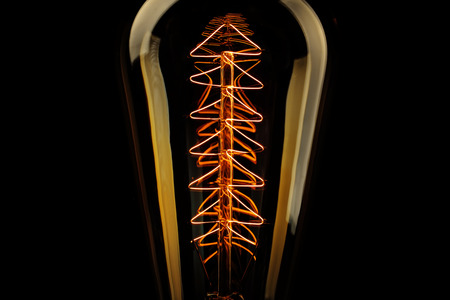 Illuminated light bulb on black backgroundの写真素材