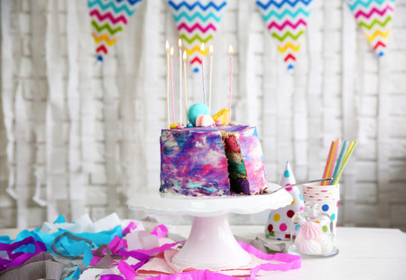 Sliced colorful cake on festive table