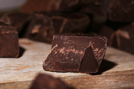 Chocolate bar pieces  on wooden background