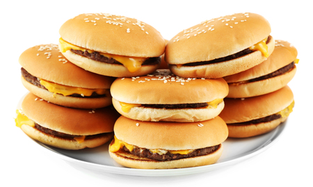 Tasty cheeseburgers on plate, isolated on whiteの写真素材