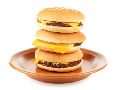 Tasty cheeseburgers on plate, isolated on whiteの写真素材