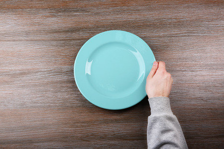 Man holding empty plate. Hunger conceptの写真素材