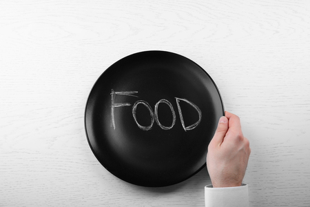 Man holding empty plate. Hunger conceptの写真素材