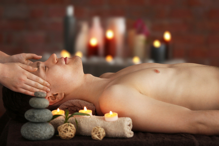 Man having facial massage in spa salonの写真素材