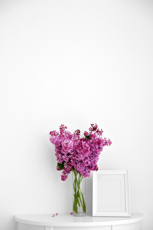 Bouquet of purple lilac flowers on white wall backgroundの写真素材