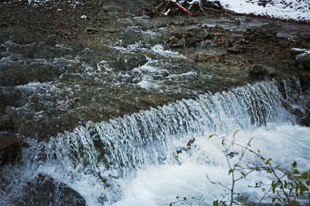 Waterfall in mountains at wintertime