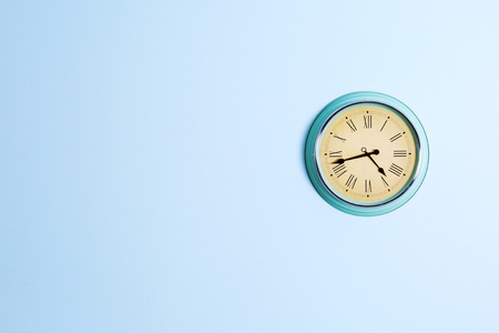 Vintage clock  on blue wall backgroundの写真素材