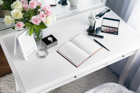 Cosmetic and notebook on light dressing tableの写真素材